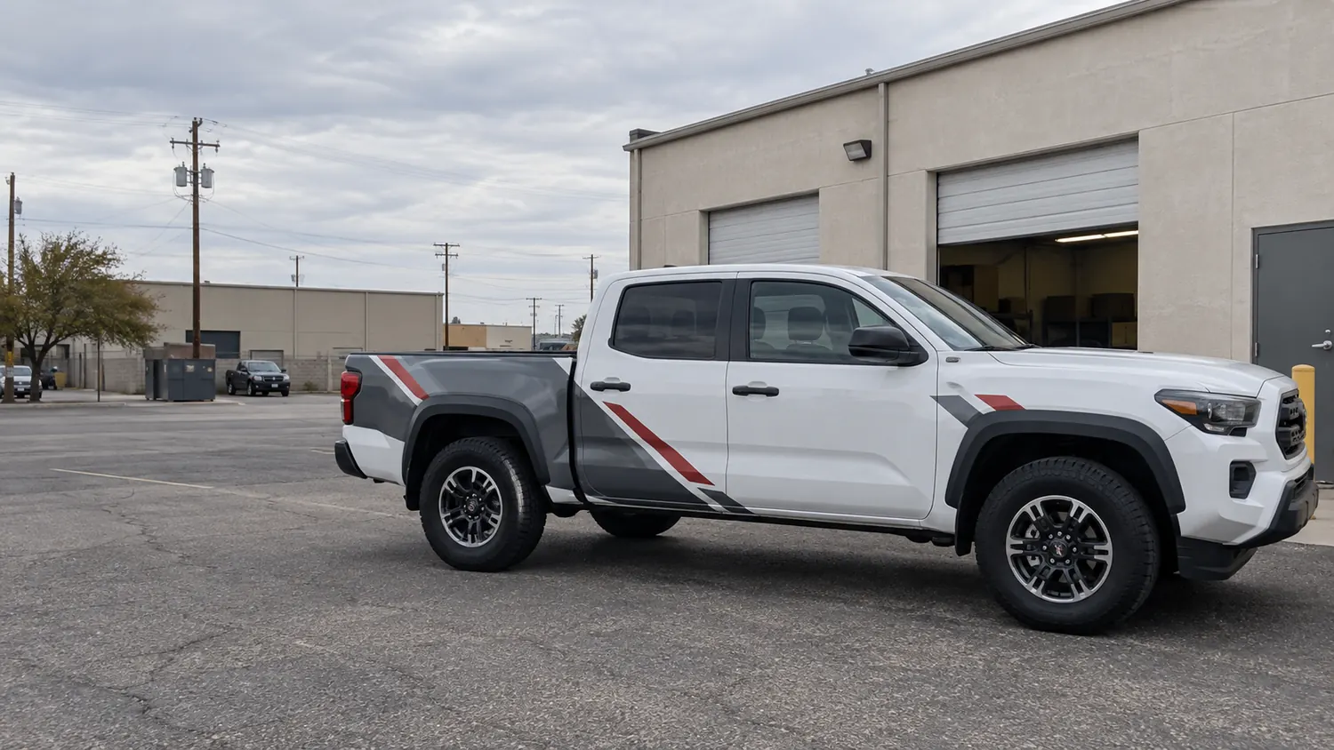 White pickup with custom charcoal and red commercial graphics