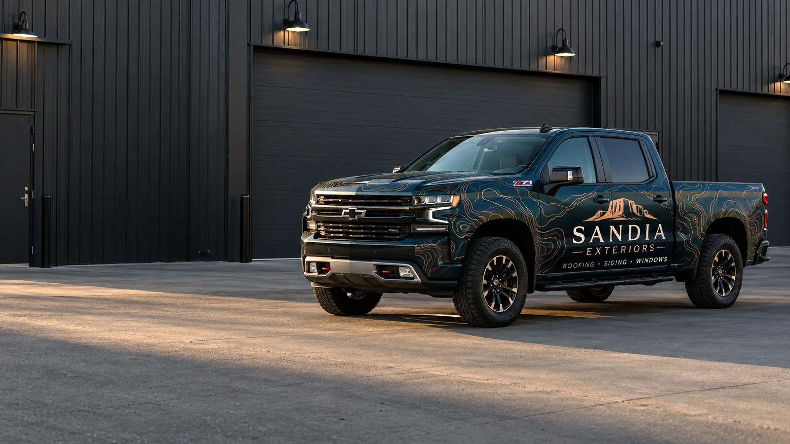 Fully wrapped Sandia Exteriors pickup outside a modern workshop